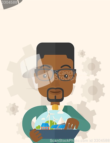 Image of Mid adult male african engineer holding blueprint.