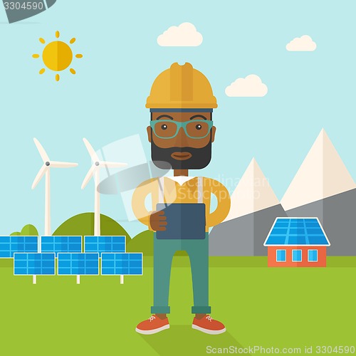 Image of Young african male standing with blueprint
