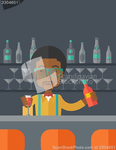 Image of African bartender at the bar holding a drinks.