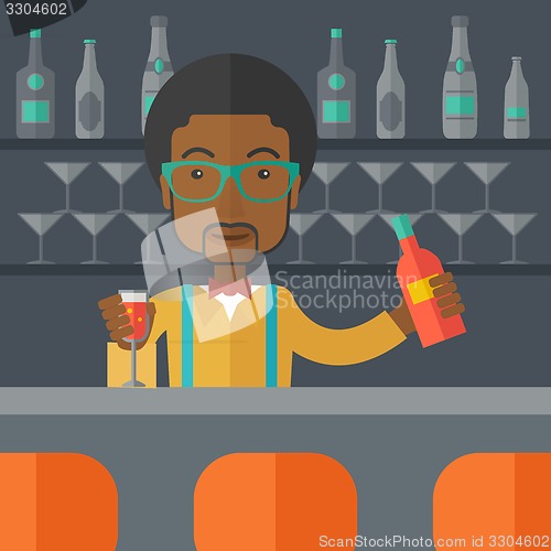 Image of African bartender at the bar holding a drinks.