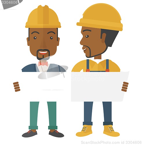 Image of Two black architects wearing protection helmets looking at blueprint. 