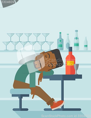 Image of African Drunk man fall asleep in the pub.