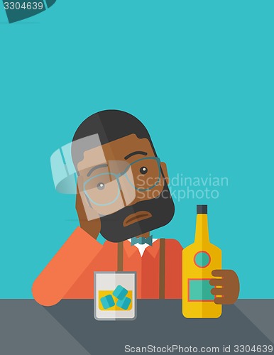 Image of Sad african man alone in the bar drinking beer.