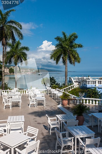 Image of White tables and chairs  in tropical garden  on a beautiful  beach