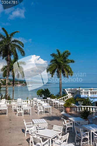 Image of White tables and chairs  in tropical garden  on a beautiful  beach