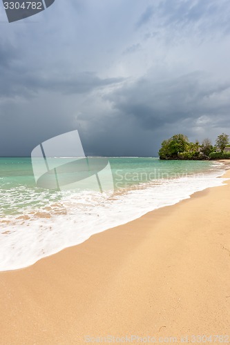 Image of Beach on tropical island. Clear blue water, sand, clouds. 