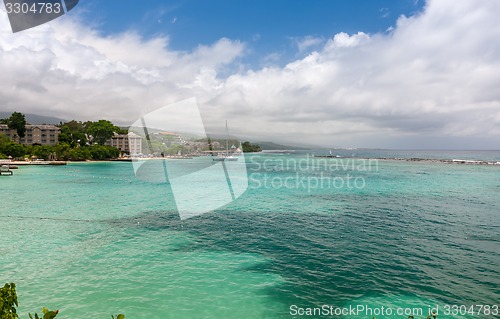 Image of Beach on tropical island. Clear blue water and sky 