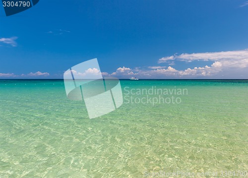 Image of Beach on tropical island. Clear blue water and sky 