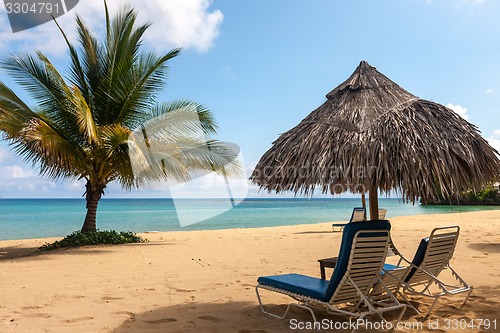 Image of Sunbed and umbrella on a tropical beach