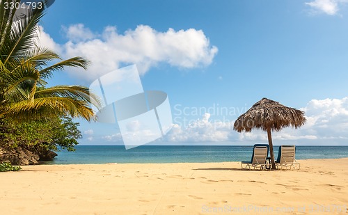 Image of Sunbed and umbrella on a tropical beach