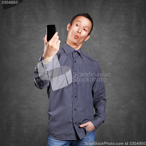 Image of Asian Man Making A Selfie
