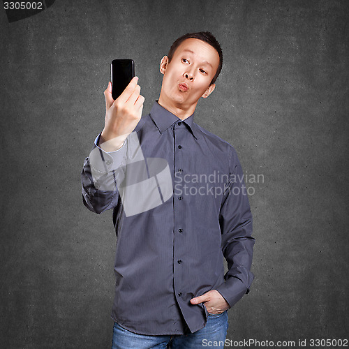 Image of Asian Man Making A Selfie