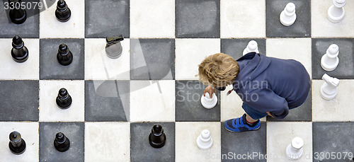 Image of Child playuing outdoor chess