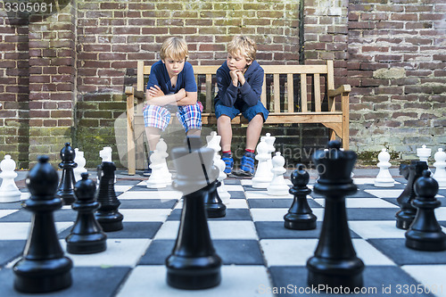 Image of Boys playing outdoor chess