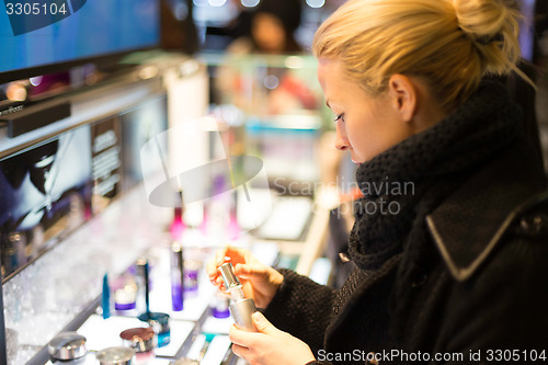 Image of Beautiful woman shopping in beauty store.