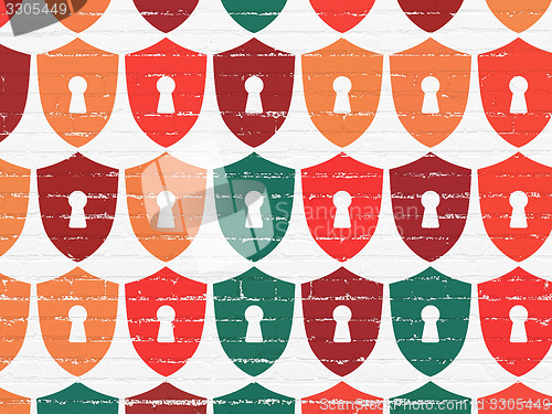 Image of Privacy concept: Shield With Keyhole icons on wall background