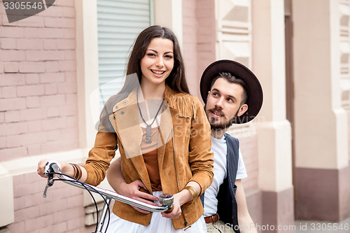 Image of Young couple standing against the wall and hugging