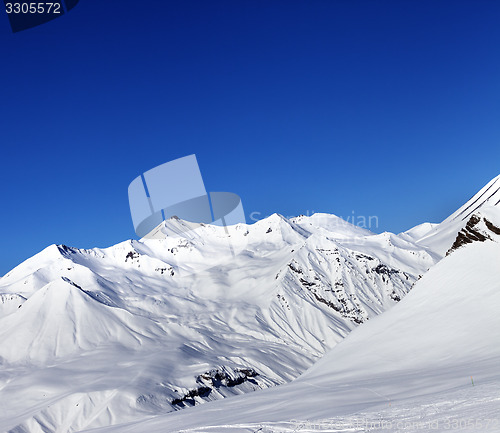 Image of View on ski slope and beautiful mountains at sun day