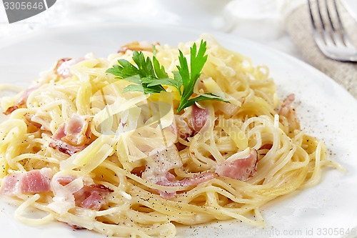 Image of pasta carbonara on white plate