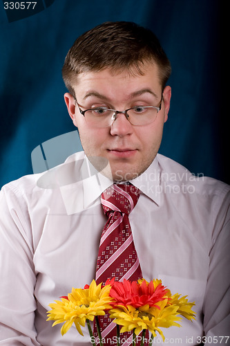 Image of Shocked man with flowers