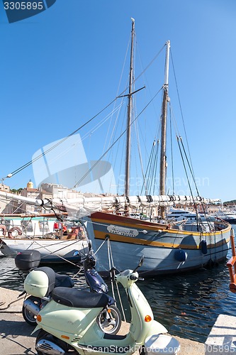 Image of SAINT TROPEZ, FRANCE -  SEPTEMBER 16, 2008: View of Saint Tropez harbor with yachts and bikes . concept of modern modes of transport rich people