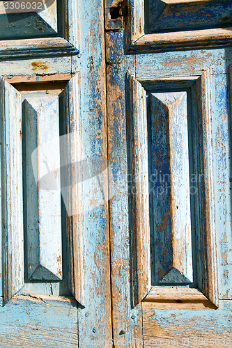 Image of dirty  paint in the blue  door  rusty nail