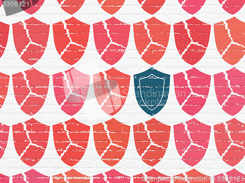 Image of Privacy concept: shield icon on wall background