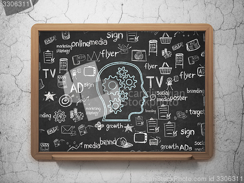 Image of Marketing concept: Head With Gears on School Board background