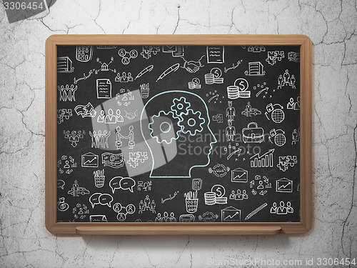 Image of Finance concept: Head With Gears on School Board background