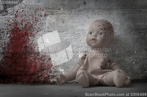 Image of Concept of child abuse - Bloody doll