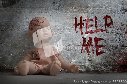 Image of Concept of child abuse - Bloody doll