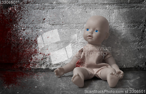 Image of Concept of child abuse - Bloody doll