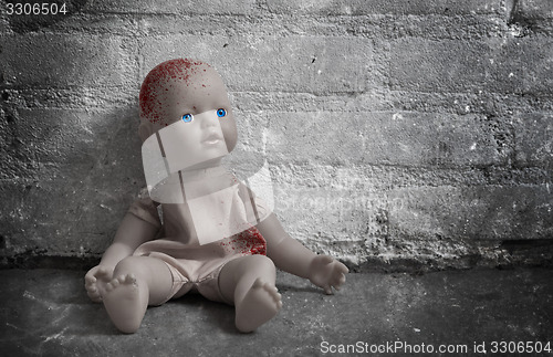 Image of Concept of child abuse - Bloody doll