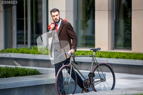 Image of Handsome businessman and his bicycle