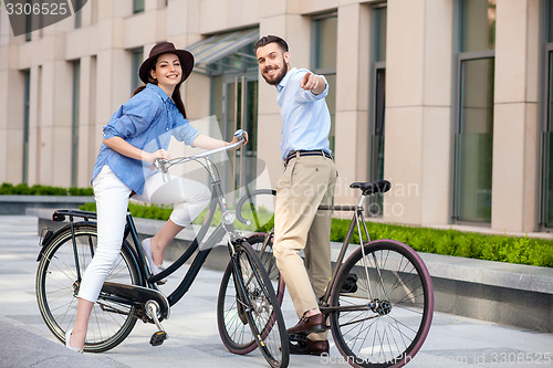 Image of Romantic date of young couple on bicycles