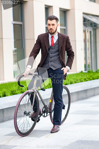 Image of Handsome businessman and his bicycle