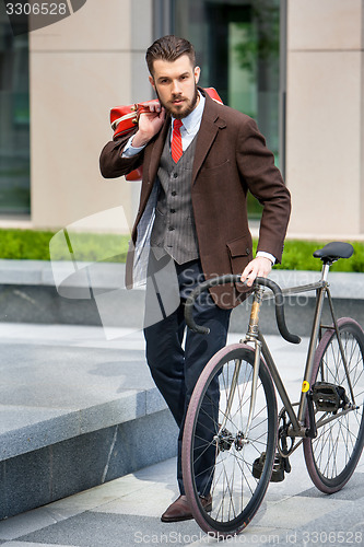 Image of Handsome businessman and his bicycle