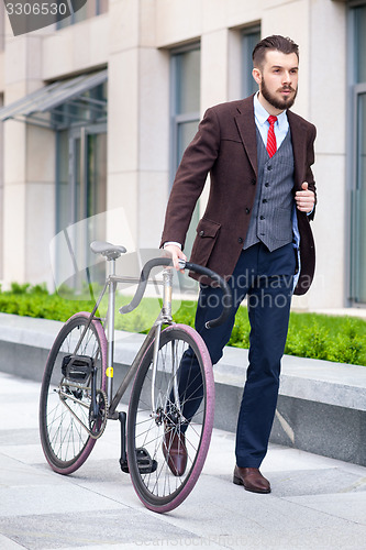 Image of Handsome businessman and his bicycle