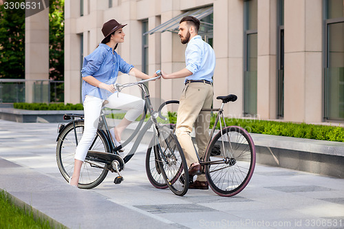 Image of Romantic date of young couple on bicycles