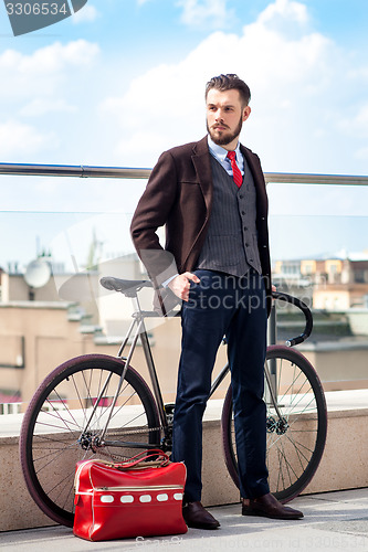 Image of Handsome businessman and his bicycle