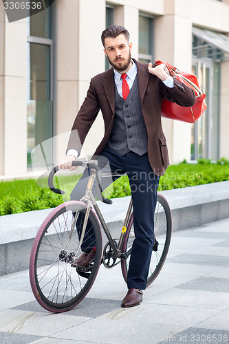 Image of Handsome businessman and his bicycle