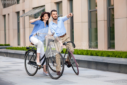 Image of Romantic date of young couple on bicycles