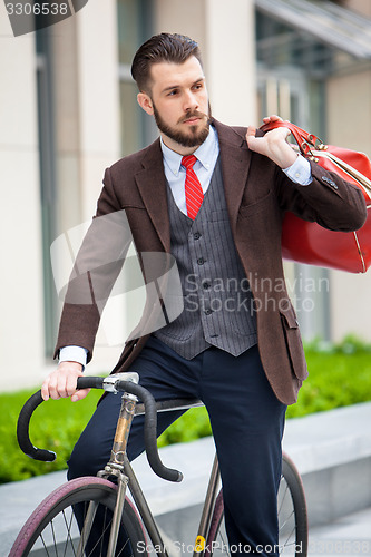 Image of Handsome businessman and his bicycle