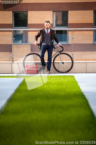Image of Handsome businessman and his bicycle