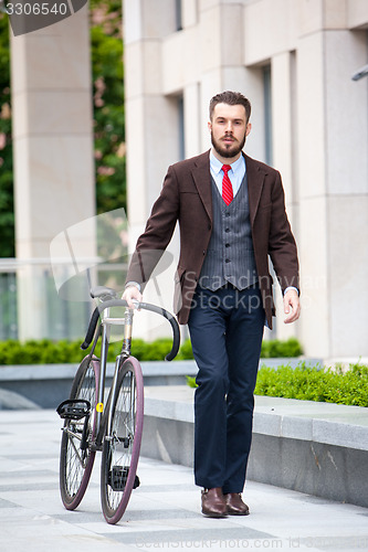 Image of Handsome businessman and his bicycle