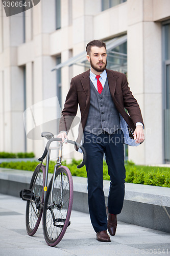 Image of Handsome businessman and his bicycle