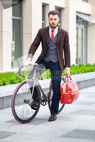 Image of Handsome businessman and his bicycle