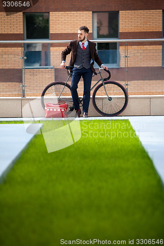 Image of Handsome businessman and his bicycle