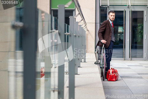 Image of Handsome businessman and his bicycle