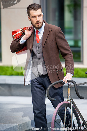 Image of Handsome businessman and his bicycle